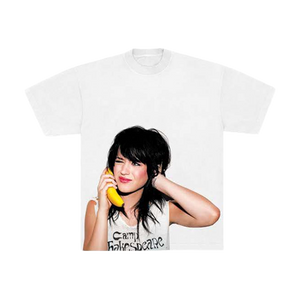 White t-shirt with a graphic of Katy Perry holding a banana phone